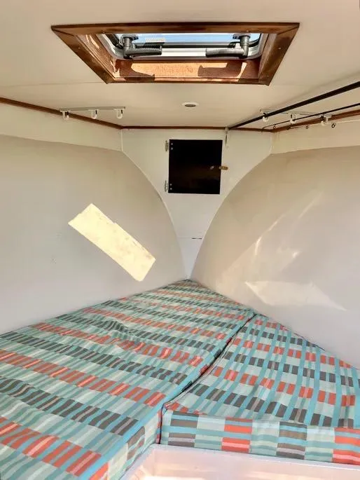 Slide: The Image of Interior cabin of 2008 Buddy Cannady 28 Custom Express boat with patterned bedding. - 13