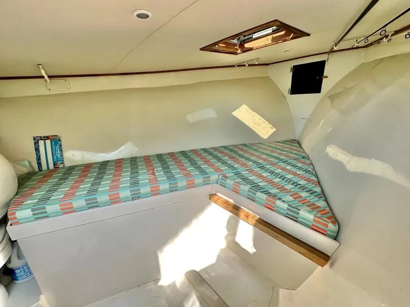 Slide: The Image of Cozy cabin interior of 2008 Buddy Cannady 28 Custom Express boat with striped bedding. - 14