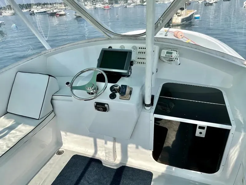 Slide: The Image of Helm of 2008 Buddy Cannady 28 Custom Express boat with steering wheel and navigation equipment. - 17