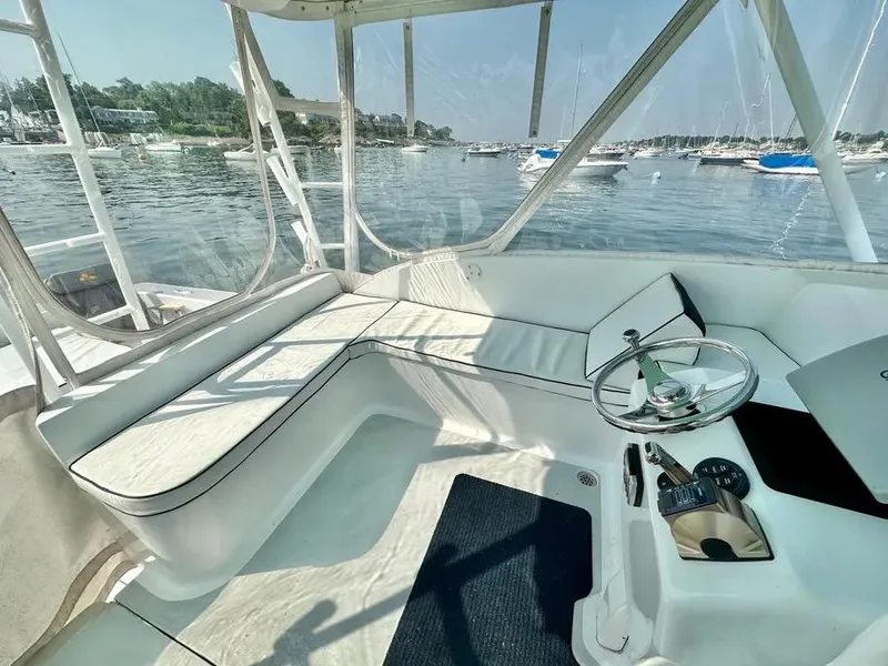Slide: The Image of 2008 Buddy Cannady 28 Custom Express boat interior with steering wheel and seating, docked in marina. - 22