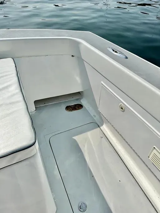 Slide: The Image of 2008 Buddy Cannady 28 Custom Express boat interior with seating and storage, near water. - 23