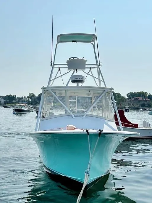 Slide: The Image of 2008 Buddy Cannady 28 Custom Express boat docked on calm water. - 3