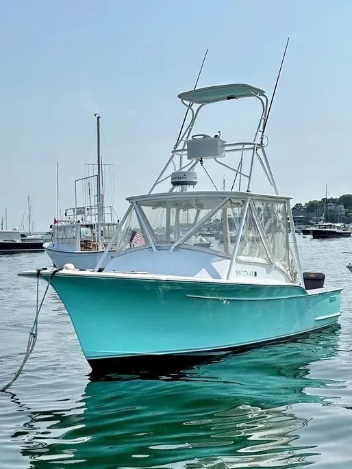 Slide: The Image of 2008 Buddy Cannady 28 Custom Express boat anchored in calm waters. - 4