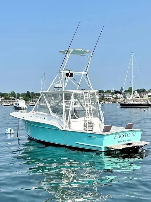 Slide: The Image of 2008 Buddy Cannady 28 Custom Express boat on calm water, named "Firstcast." - 6