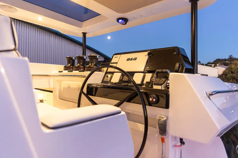 Slide: The Image of Helm of 2026 Knysna 550 yacht with modern navigation equipment at sunset. - 4