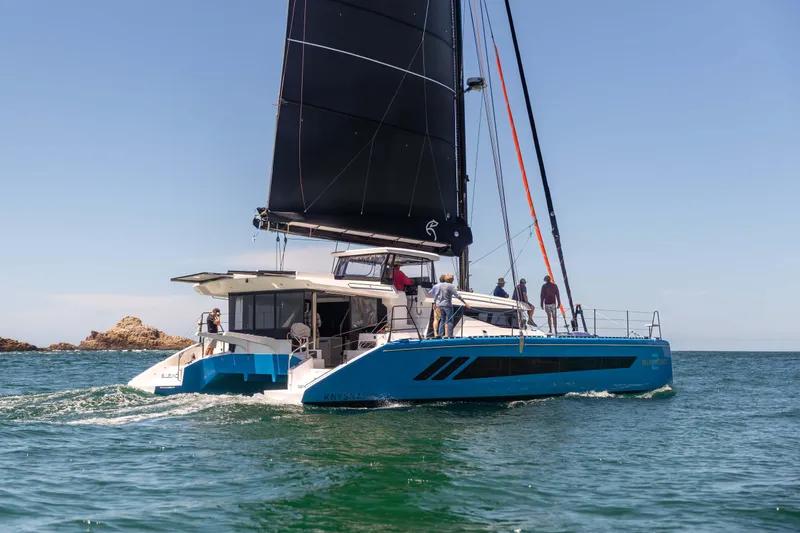 The Image of 2026 Knysna 550 catamaran sailing on open water with crew onboard. - 0