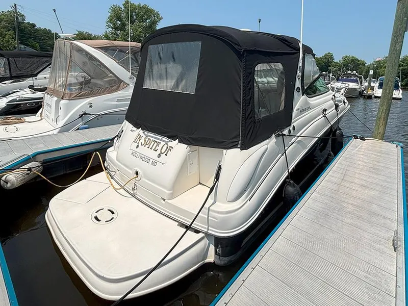 The Image of 2007 Sea Ray 280 Sundancer docked at marina, featuring black canopy and white hull. - 0