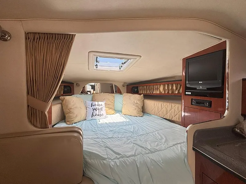 Slide: The Image of Interior cabin of 2007 Sea Ray 280 Sundancer with cozy bed and TV. - 13