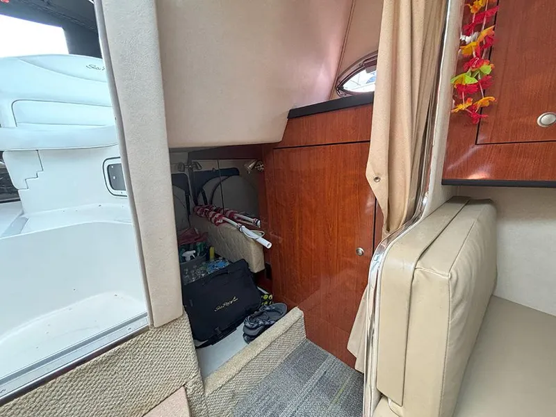 Slide: The Image of Interior cabin of 2007 Sea Ray 280 Sundancer with wood paneling and seating. - 16