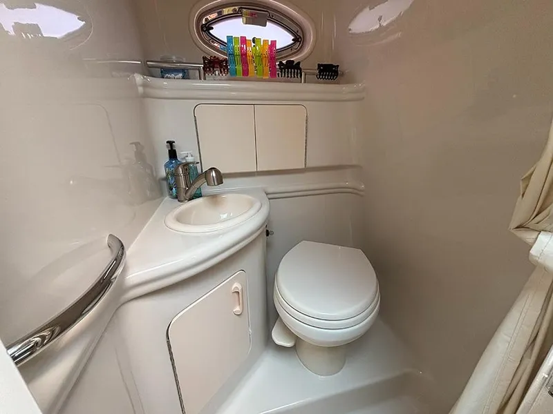Slide: The Image of 2007 Sea Ray 280 Sundancer bathroom with sink, toilet, and storage cabinets. - 17