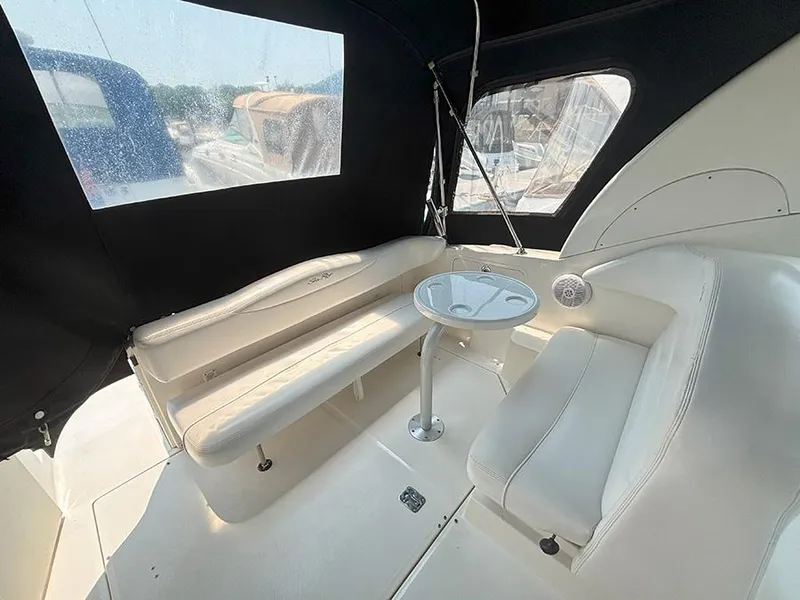 Slide: The Image of 2007 Sea Ray 280 Sundancer interior with seating and table, featuring a covered cockpit area. - 4
