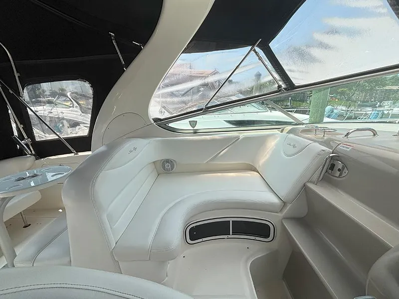 Slide: The Image of Interior of a 2007 Sea Ray 280 Sundancer boat with white seating and windows. - 7