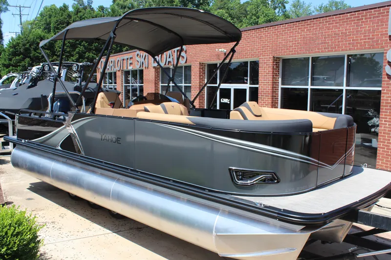 The Image of 2025 Tahoe Pontoon LTZ Versatile Rear Lounger at dealership, sleek design, outdoor display. - 1