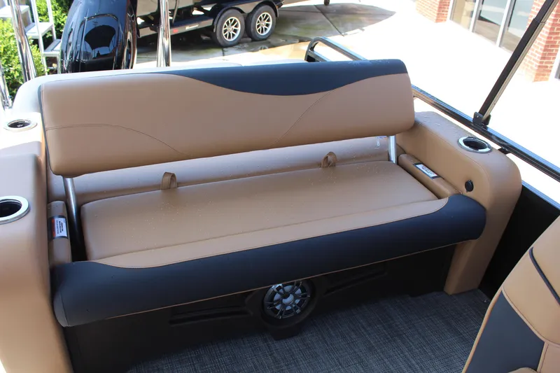 Slide: The Image of 2025 Tahoe Pontoon LTZ Versatile Rear Lounger with tan and black seating, cup holders, and speaker. - 13