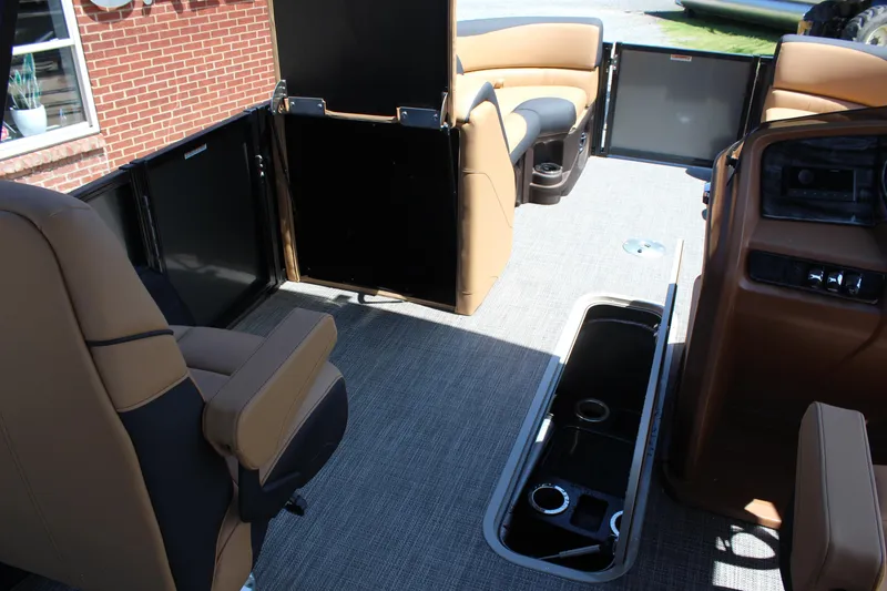 Slide: The Image of 2025 Tahoe Pontoon LTZ Versatile Rear Lounger interior with tan seating and storage compartments. - 14