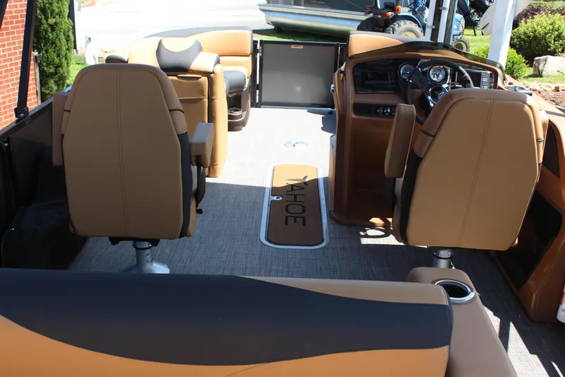 Slide: The Image of 2025 Tahoe Pontoon LTZ Versatile Rear Lounger interior with tan seating and modern dashboard. - 6