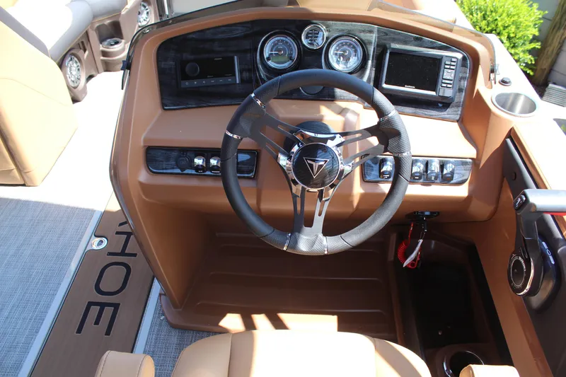 Slide: The Image of 2025 Tahoe Pontoon LTZ Versatile Rear Lounger dashboard with steering wheel and controls. - 7