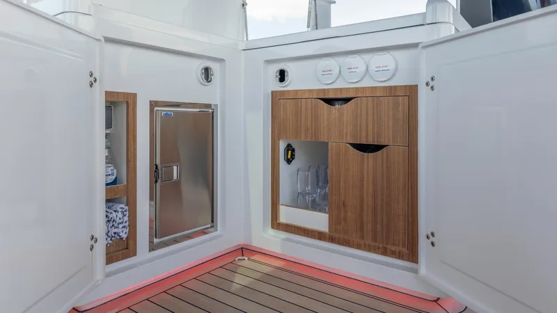 Slide: The Image of Interior of Fjord 53XL yacht with wooden cabinets and refrigerator. - 7