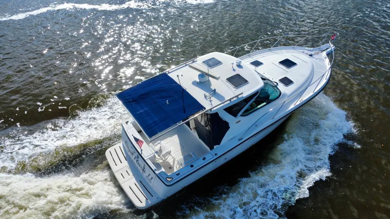 Slide: The Image of 2006 Tiara Yachts 3200 Open cruising on water, aerial view. - 10