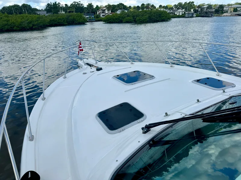 Slide: The Image of 2006 Tiara Yachts 3200 Open on calm water, showcasing sleek deck design. - 13