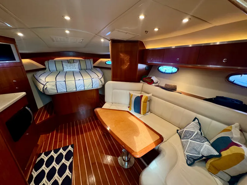 Slide: The Image of Luxurious interior of 2006 Tiara Yachts 3200 Open with cozy seating and elegant wood finishes. - 2
