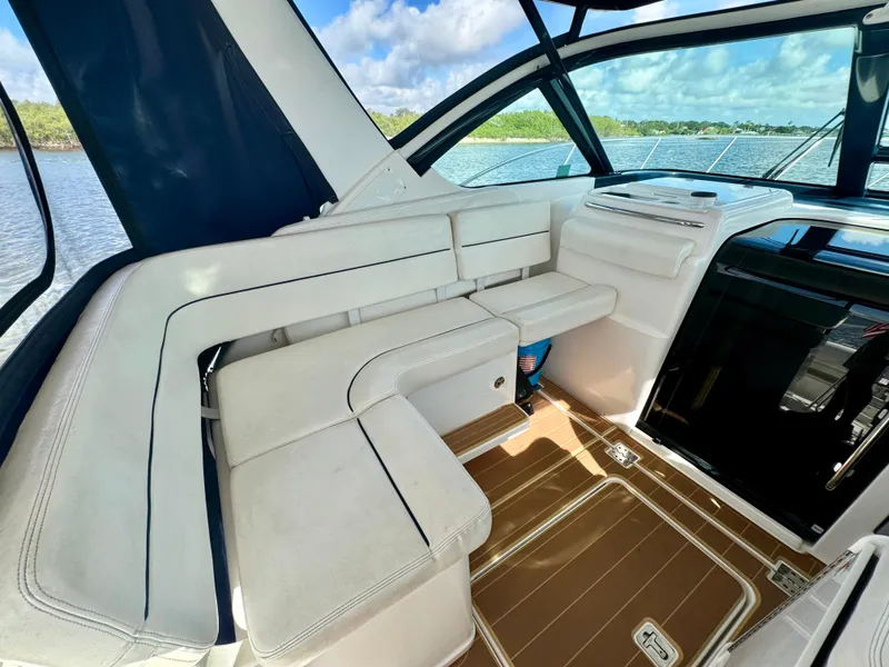 Slide: The Image of 2006 Tiara Yachts 3200 Open interior with white seating and scenic water view. - 22