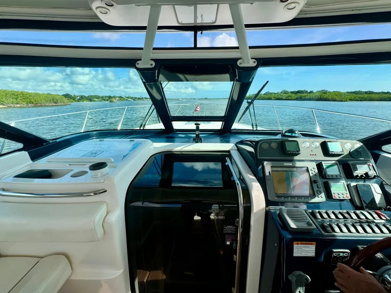 Slide: The Image of 2006 Tiara Yachts 3200 Open cockpit with navigation equipment, cruising on a scenic waterway. - 23