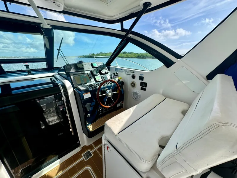 Slide: The Image of 2006 Tiara Yachts 3200 Open helm with modern controls and ocean view. - 25
