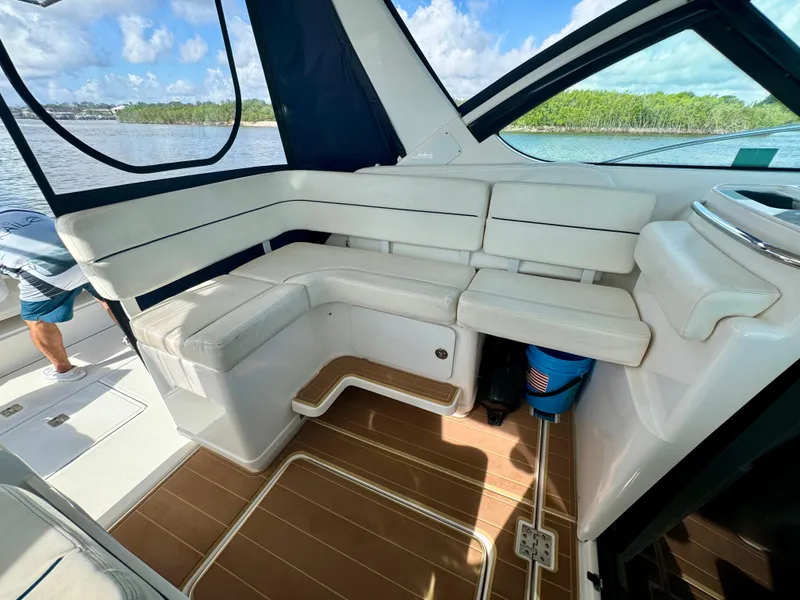 Slide: The Image of 2006 Tiara Yachts 3200 Open interior with white seating and wooden flooring. - 27