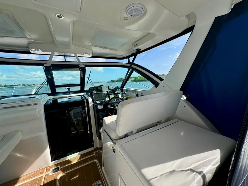 Slide: The Image of 2006 Tiara Yachts 3200 Open cockpit with helm, overlooking serene waters. - 28