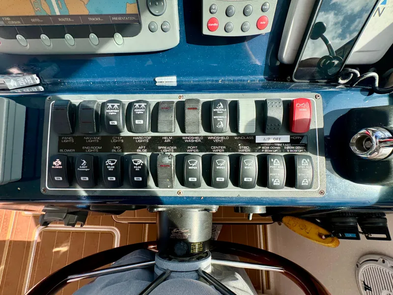 Slide: The Image of Control panel of a 2006 Tiara Yachts 3200 Open, featuring various switches and controls. - 30