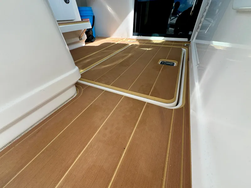 Slide: The Image of 2006 Tiara Yachts 3200 Open interior with teak flooring and storage compartment. - 31