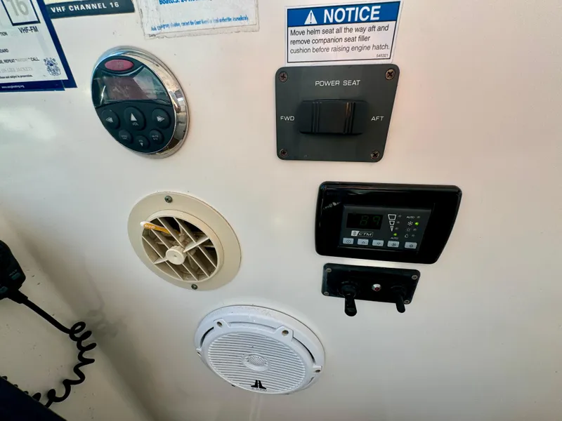 Slide: The Image of Control panel of a 2006 Tiara Yachts 3200 Open with various switches and displays. - 32