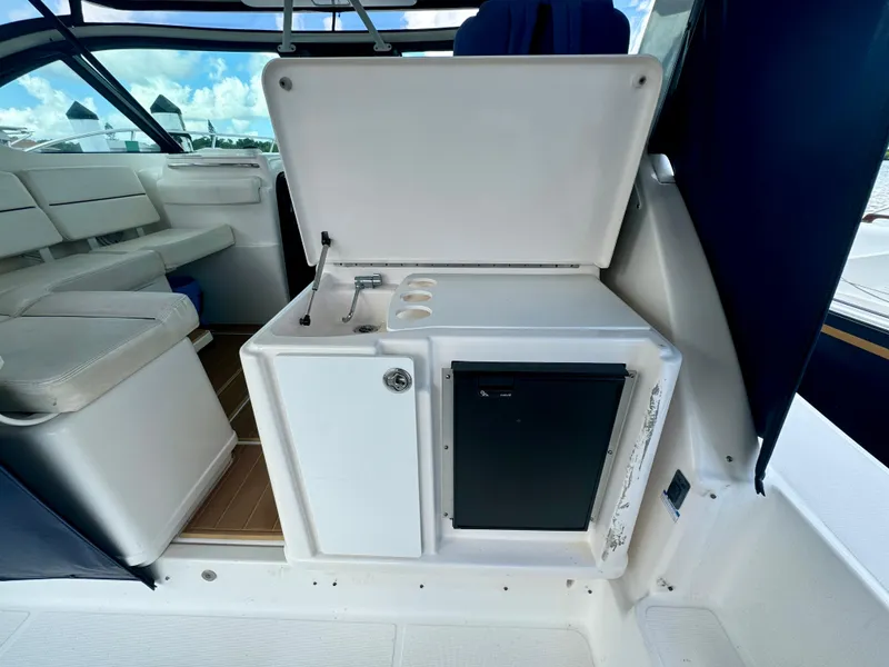 Slide: The Image of 2006 Tiara Yachts 3200 Open interior with seating and kitchenette area. - 33