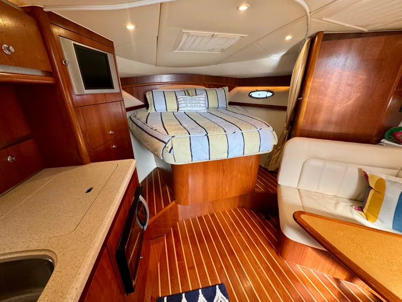 Slide: The Image of 2006 Tiara Yachts 3200 Open cabin interior with bed, kitchenette, and seating area. - 35