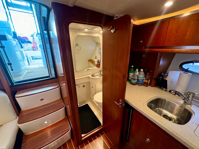 Slide: The Image of 2006 Tiara Yachts 3200 Open interior with kitchenette and bathroom. - 38
