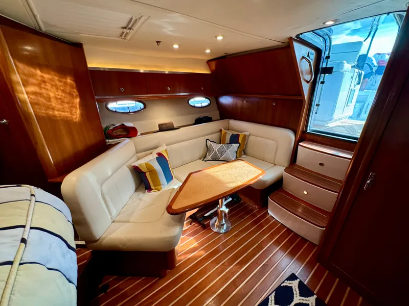 Slide: The Image of Luxurious 2006 Tiara Yachts 3200 Open interior with elegant seating and wooden accents. - 42