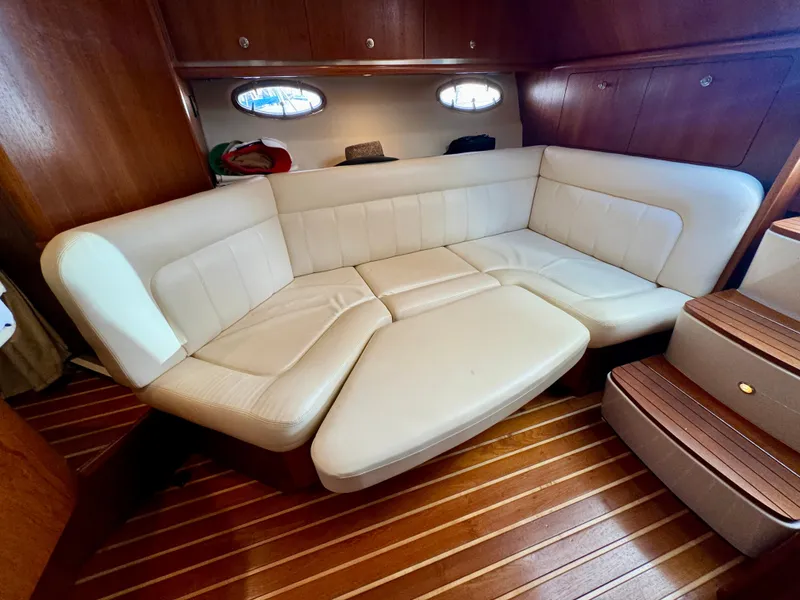 Slide: The Image of Luxurious interior of 2006 Tiara Yachts 3200 Open with cream leather seating and wooden flooring. - 43
