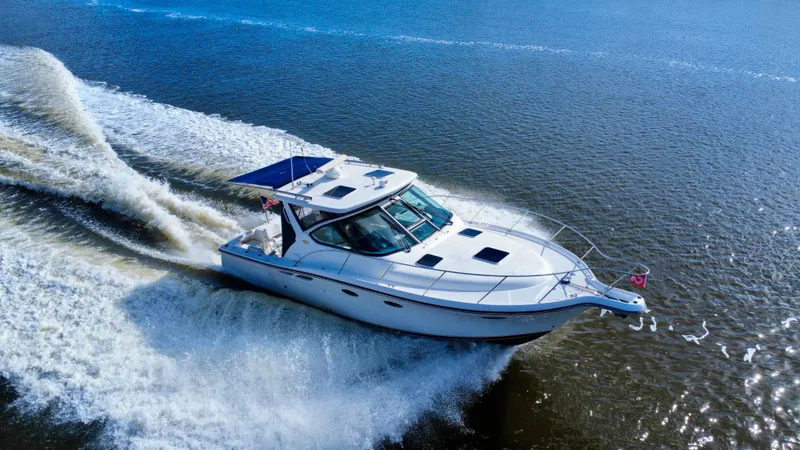 Slide: The Image of 2006 Tiara Yachts 3200 Open cruising on open water, creating a dynamic wake. - 5