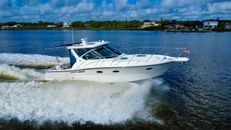 Slide: The Image of 2006 Tiara Yachts 3200 Open cruising on a scenic waterway under a blue sky. - 6