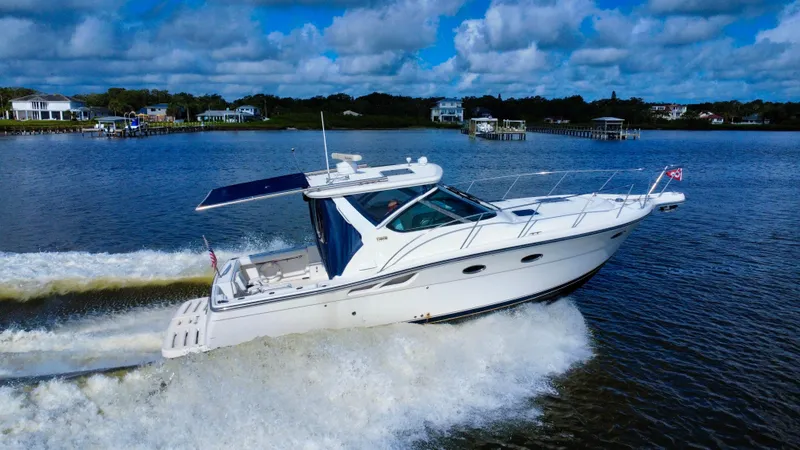 Slide: The Image of 2006 Tiara Yachts 3200 Open cruising on a scenic waterway under a blue sky. - 7
