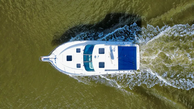 Slide: The Image of Aerial view of 2006 Tiara Yachts 3200 Open cruising on water. - 9