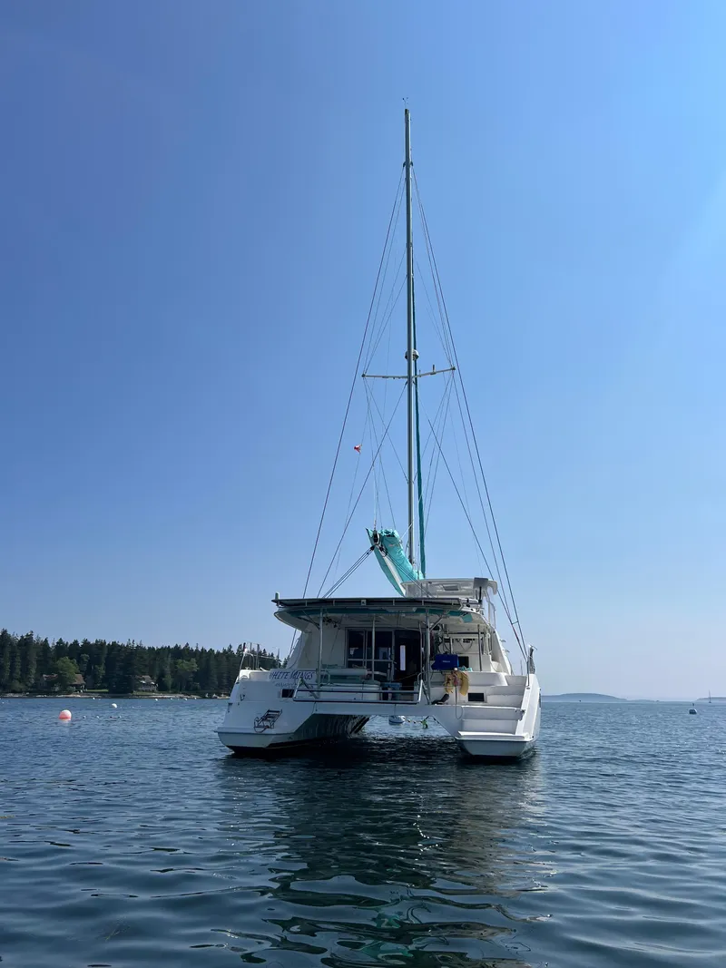 Slide: The Image of Interior hallway of 2013 Leopard 48 yacht, featuring wooden doors and cozy cabin. - 117