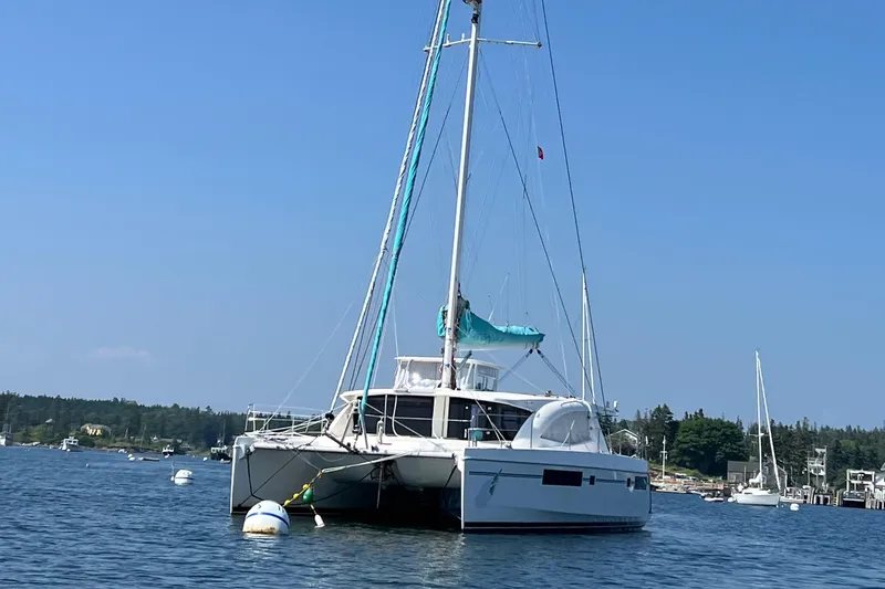 Slide: The Image of Compact bathroom in a 2013 Leopard 48 yacht, featuring sink, toilet, and storage shelves. - 123