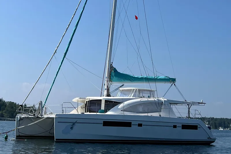 Slide: The Image of Cozy cabin interior of 2013 Leopard 48 yacht with blue bedding and wooden furnishings. - 125