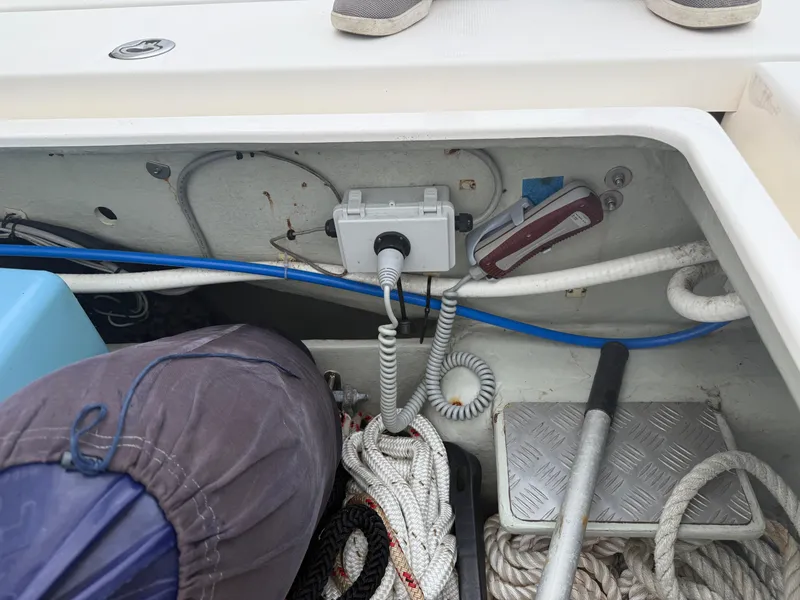 Slide: The Image of 2013 Leopard 48 yacht with teal awning, docked at marina with sailboats. - 14