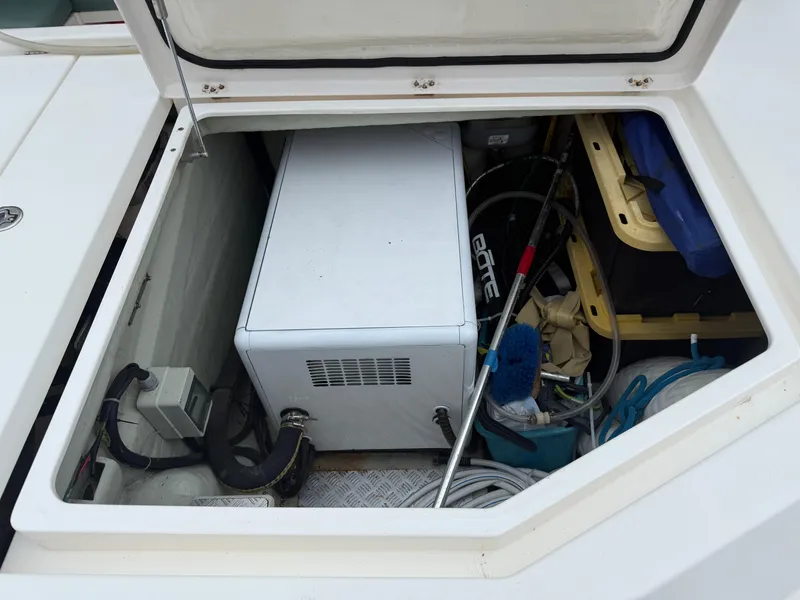 Slide: The Image of Open compartment on a 2013 Leopard 48 yacht, showing mechanical components and ropes. - 16