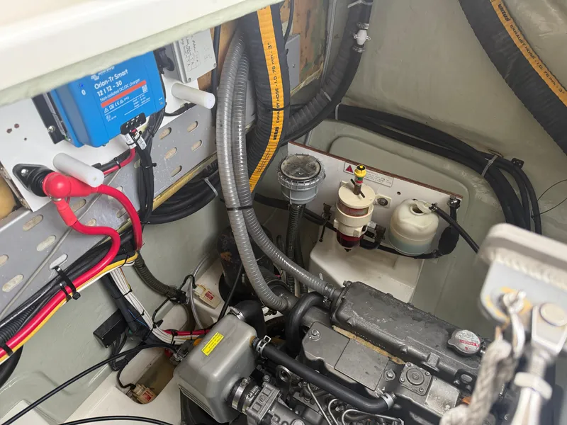 Slide: The Image of Engine compartment of a 2013 Leopard 48 yacht, featuring various mechanical components and fluid containers. - 20