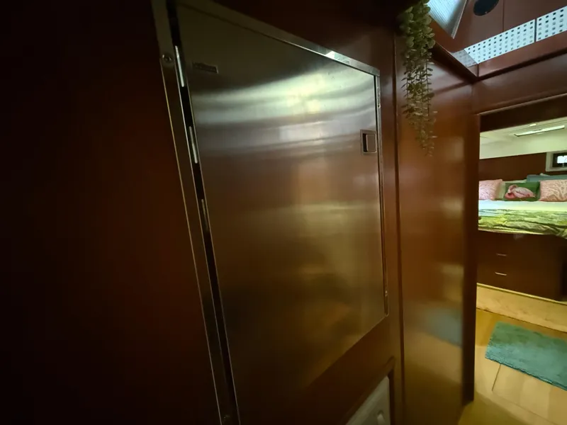 Slide: The Image of Interior hallway of 2013 Leopard 48 yacht with wooden paneling and blue rugs. - 29