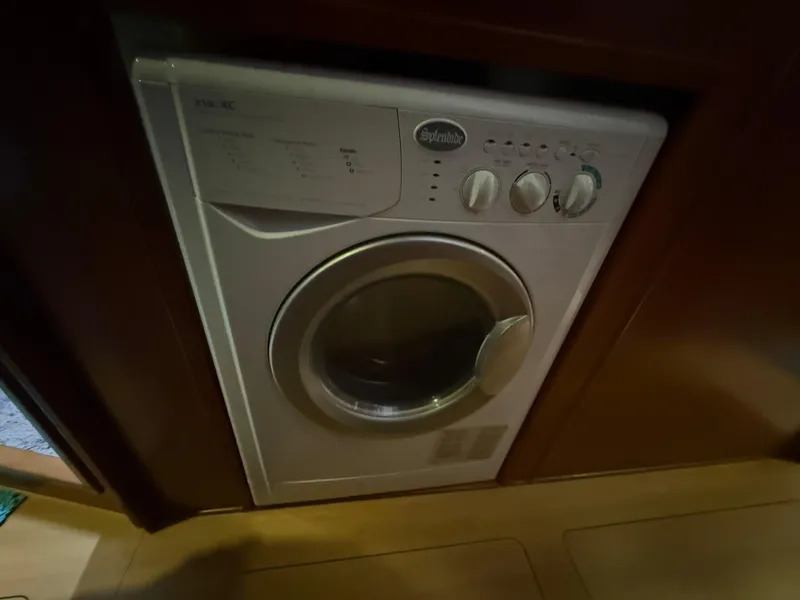 Slide: The Image of Cozy bedroom in 2013 Leopard 48 yacht with teal bedding and wooden cabinetry. - 30